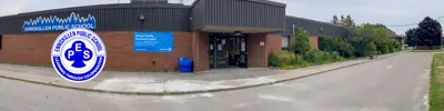 exterior picture of Enniskillen Public School and their logo