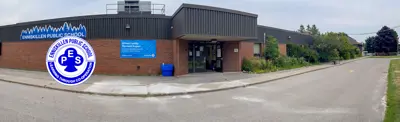exterior picture of Enniskillen Public School and their logo