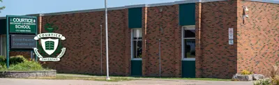 exterior picture of Courtice Secondary School and the school logo