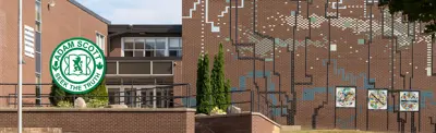 exterior picture of Adam Scott Intermediate School and their logo