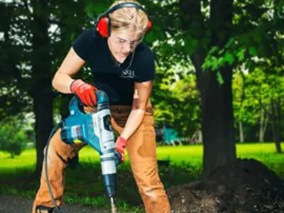 a student using a hammer drill