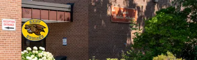 exterior picture of Kent Public School and their logo