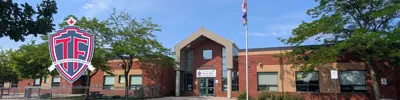 exterior picture of Terry Fox Public School and their logo