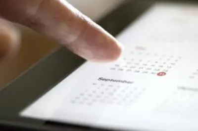 finger pointing at a calendar