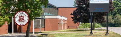exterior picture of Dr. M.S. Hawkins Senior Public School and their logo