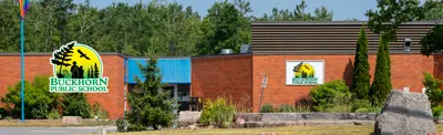 exterior picture of Buckhorn Public School and their logo