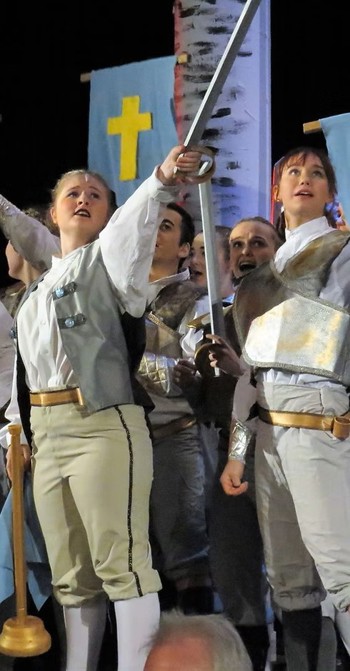 actors performing in costume with a sword