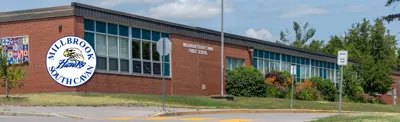 exterior picture of Millbrook/South Cavan Public School and their logo
