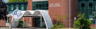 exterior picture of Port Hope High School and their logo